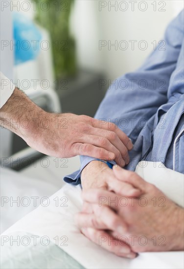 Caucasian doctor reassuring patient in hospital