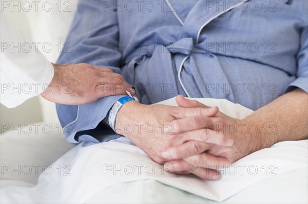 Caucasian doctor reassuring patient in hospital