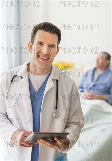 Caucasian doctor using digital tablet in hospital