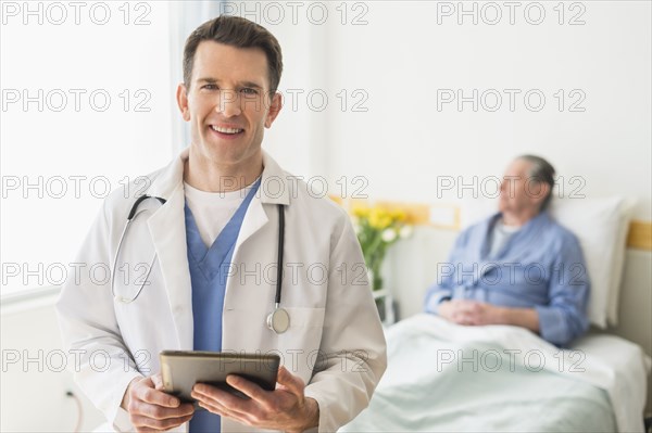 Caucasian doctor using digital tablet in hospital