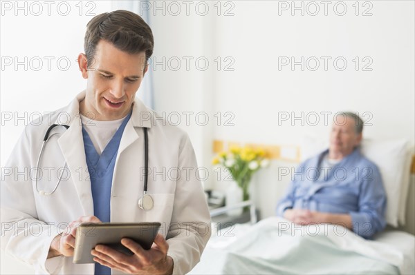 Caucasian doctor using digital tablet in hospital