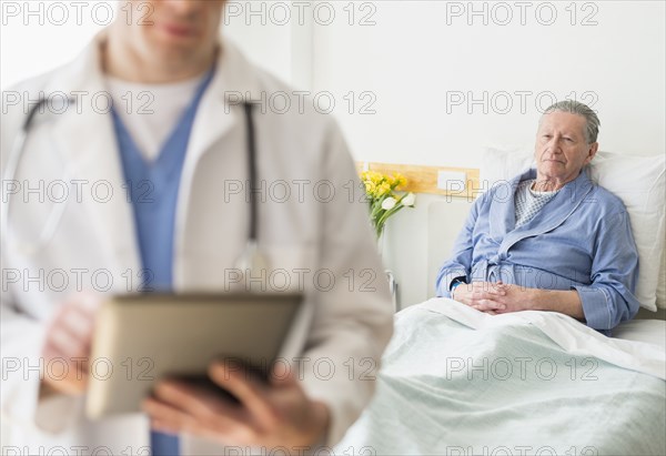 Senior Caucasian man sitting in hospital bed