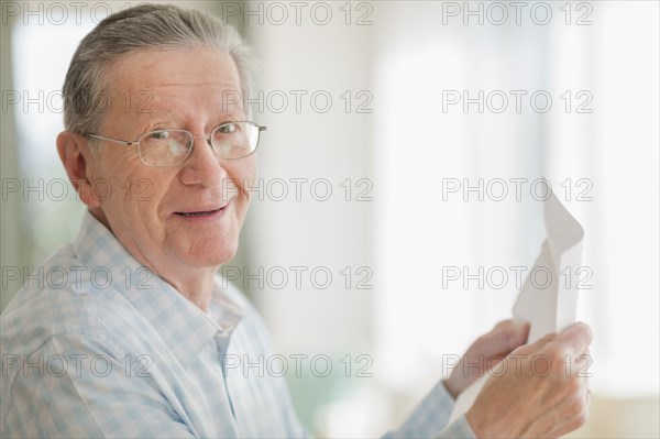 Senior Caucasian man reading letter