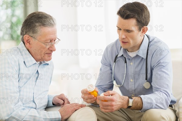 Caucasian doctor and patient discussing medication at home