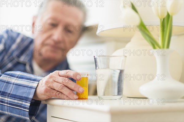 Senior Caucasian man taking medication