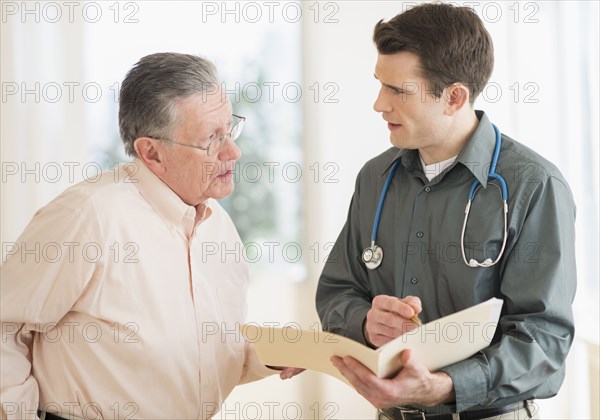 Caucasian doctor and patient talking in office