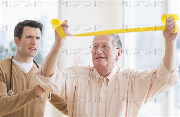 Senior Caucasian man working with physical therapist