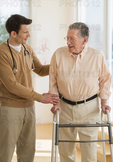 Senior Caucasian man working with physical therapist