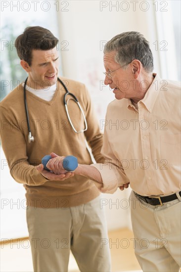 Senior Caucasian man working with physical therapist