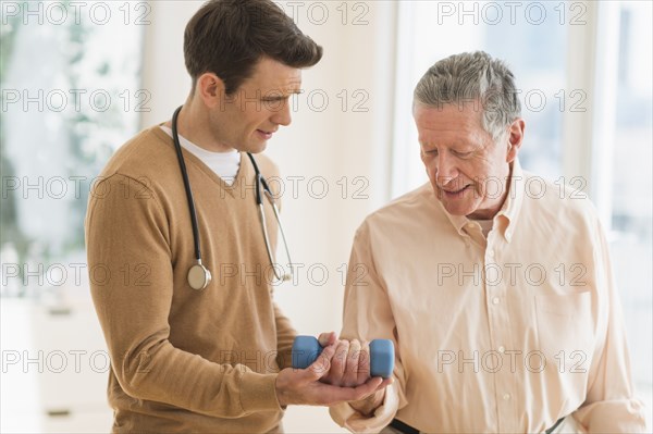 Senior Caucasian man working with physical therapist