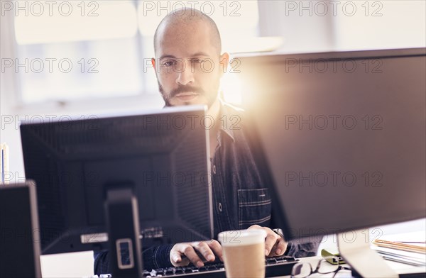 Hispanic businessman working at desk