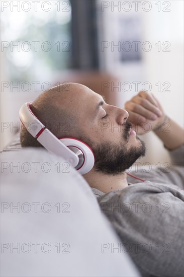 Hispanic man listening to headphones