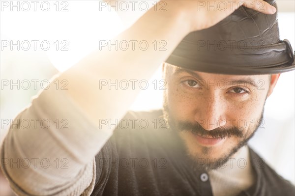 Hispanic man tipping his hat