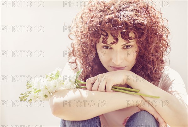 Hispanic woman holding bouquet of flowers