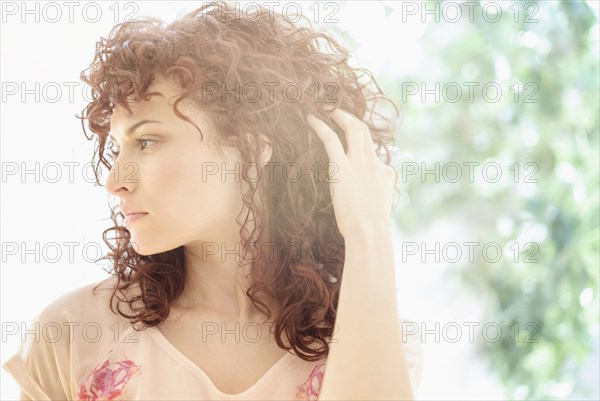 Hispanic woman tossing her hair