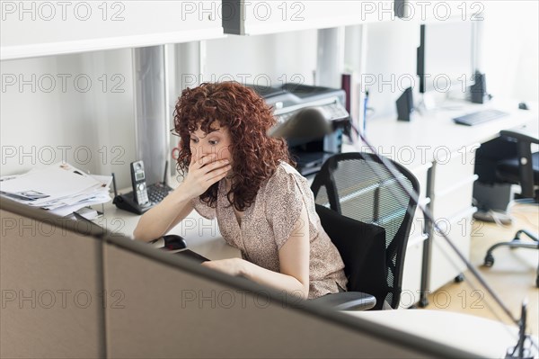 Hispanic businesswoman working in office