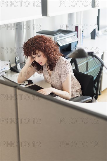 Hispanic businesswoman working in office