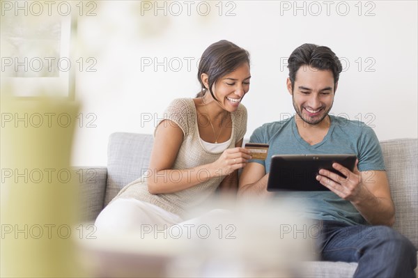 Couple shopping together on digital tablet