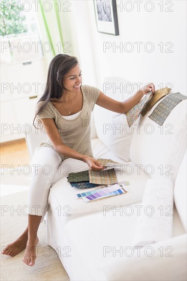 Hispanic woman picking out fabric swatches