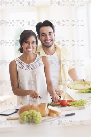 Couple cooking together in kitchen