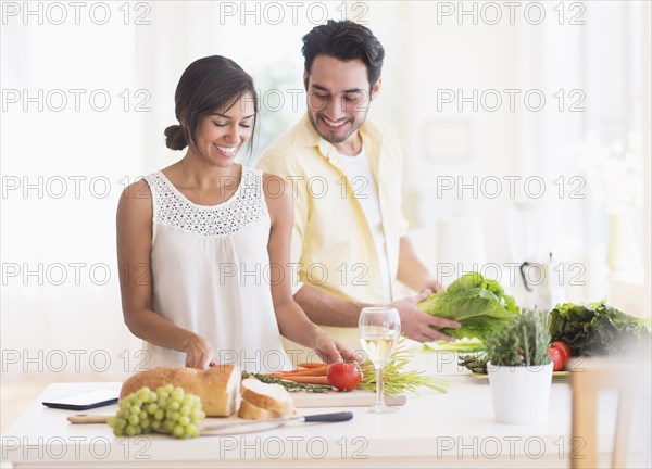 Couple cooking together in kitchen