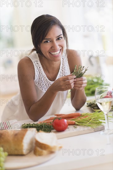 Hispanic woman cooking in kitchen