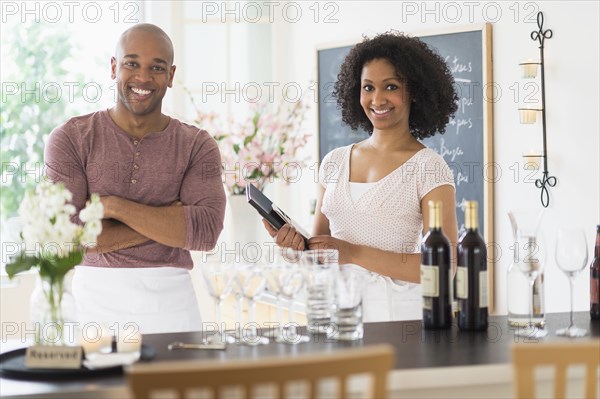 Servers smiling in restaurant