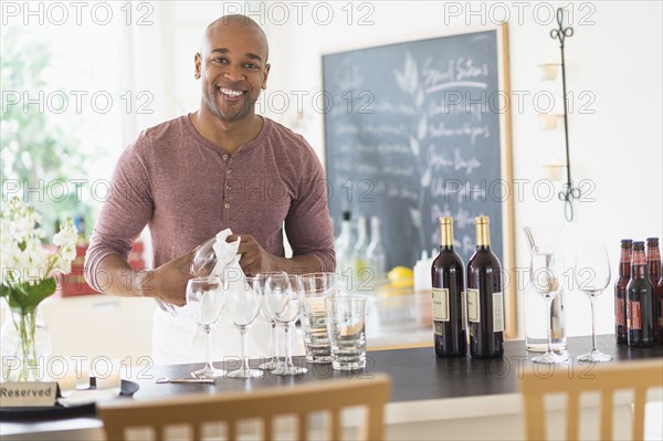 Black bartender smiling in restaurant