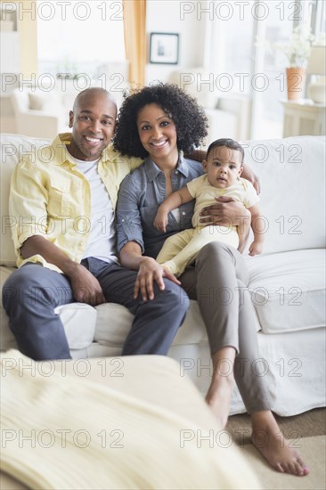Family smiling together in living room