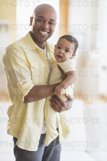 Smiling father holding baby