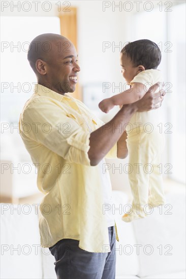 Smiling father holding baby