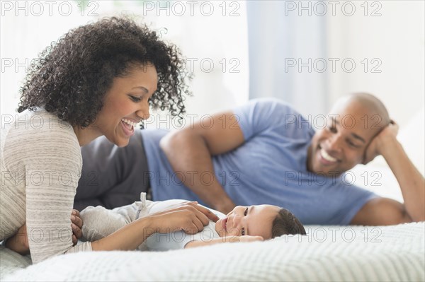 Family relaxing together on bed