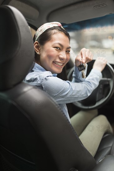 Mixed race teenage girl holding keys to car