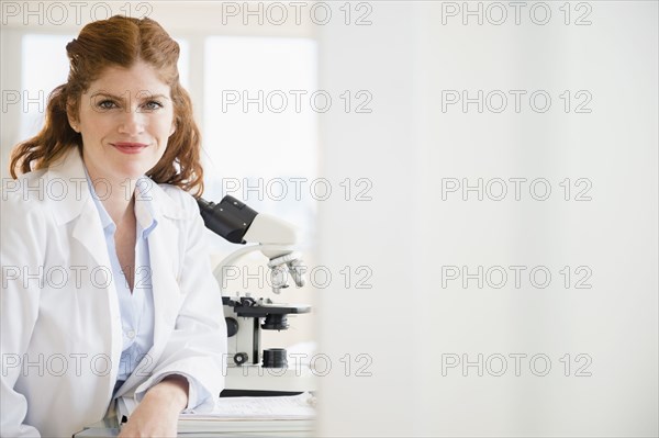 Caucasian scientist smiling in lab