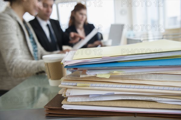 Stack of papers on desk in office