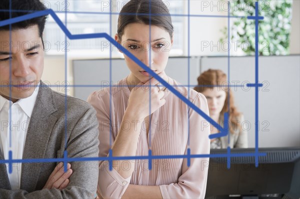 Business people examining graph on window