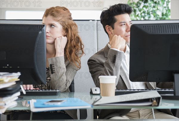 Business people bored at desks