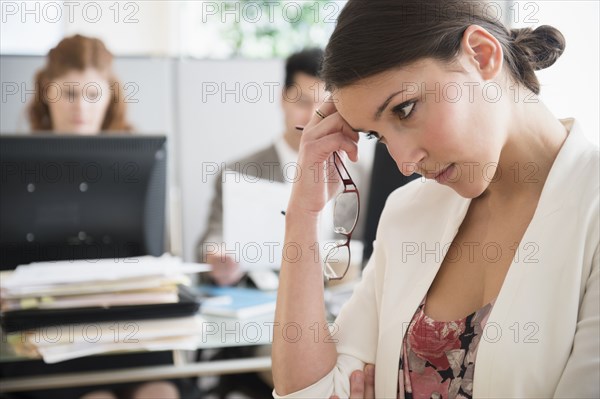 Businesswoman scratching her head in office