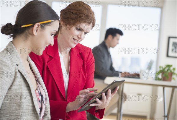 Businesswomen using digital tablet in office