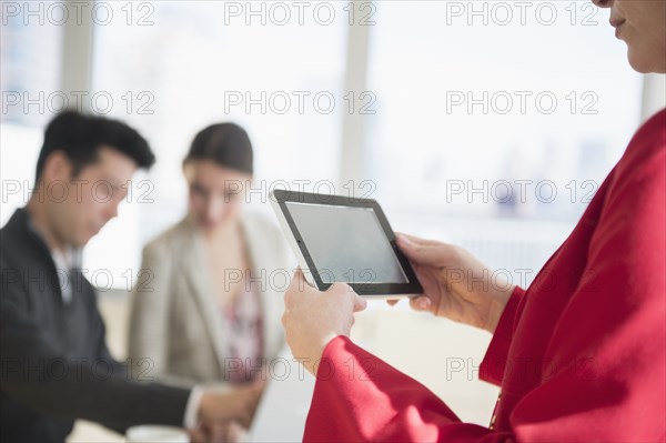 Businesswoman using digital tablet in office