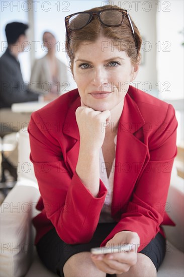 Businesswoman using cell phone in office