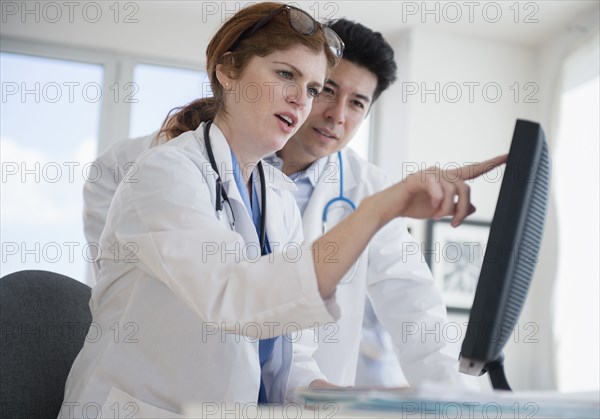 Doctors using touch screen computer in office