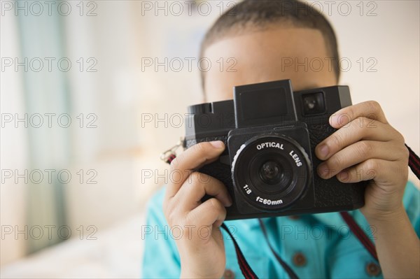 Mixed race boy taking pictures