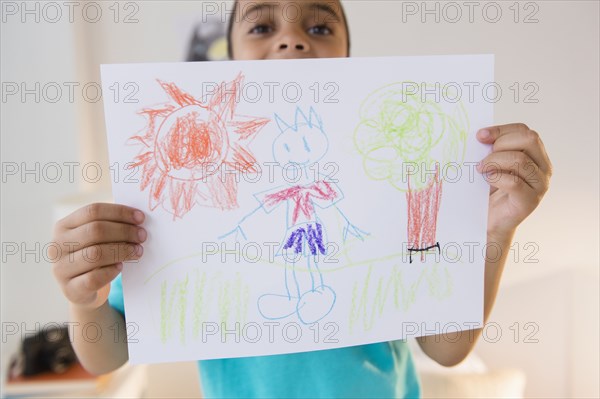 Mixed race boy displaying drawing