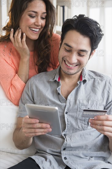 Couple shopping together on tablet computer