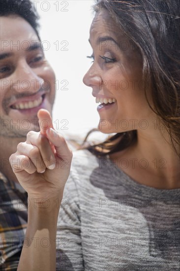 Smiling couple window shopping together