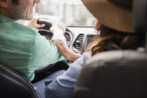 Couple driving together in car