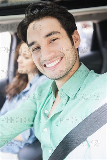 Man smiling in car