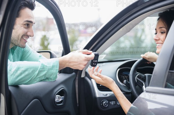 Man giving girlfriend keys to car