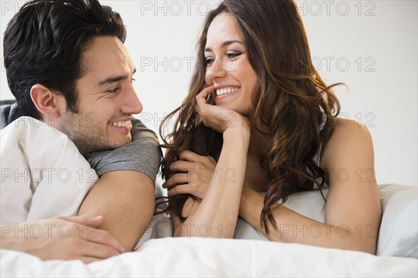 Couple relaxing together in bed